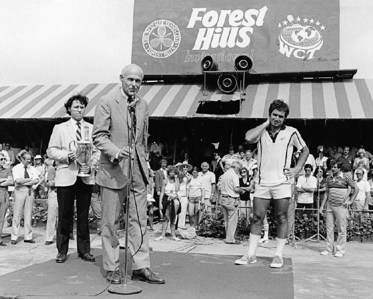 [Left to Right] Operations Director, Derek Bryson Park; Tournament Chairman and President of the Interpublic Group of Companies [NYSE: “IPG”] J. Donald McNamara Presenting the Championship Trophy to American Tennis Star, Eddie Dibbs; Forest Hills Invitational, New York